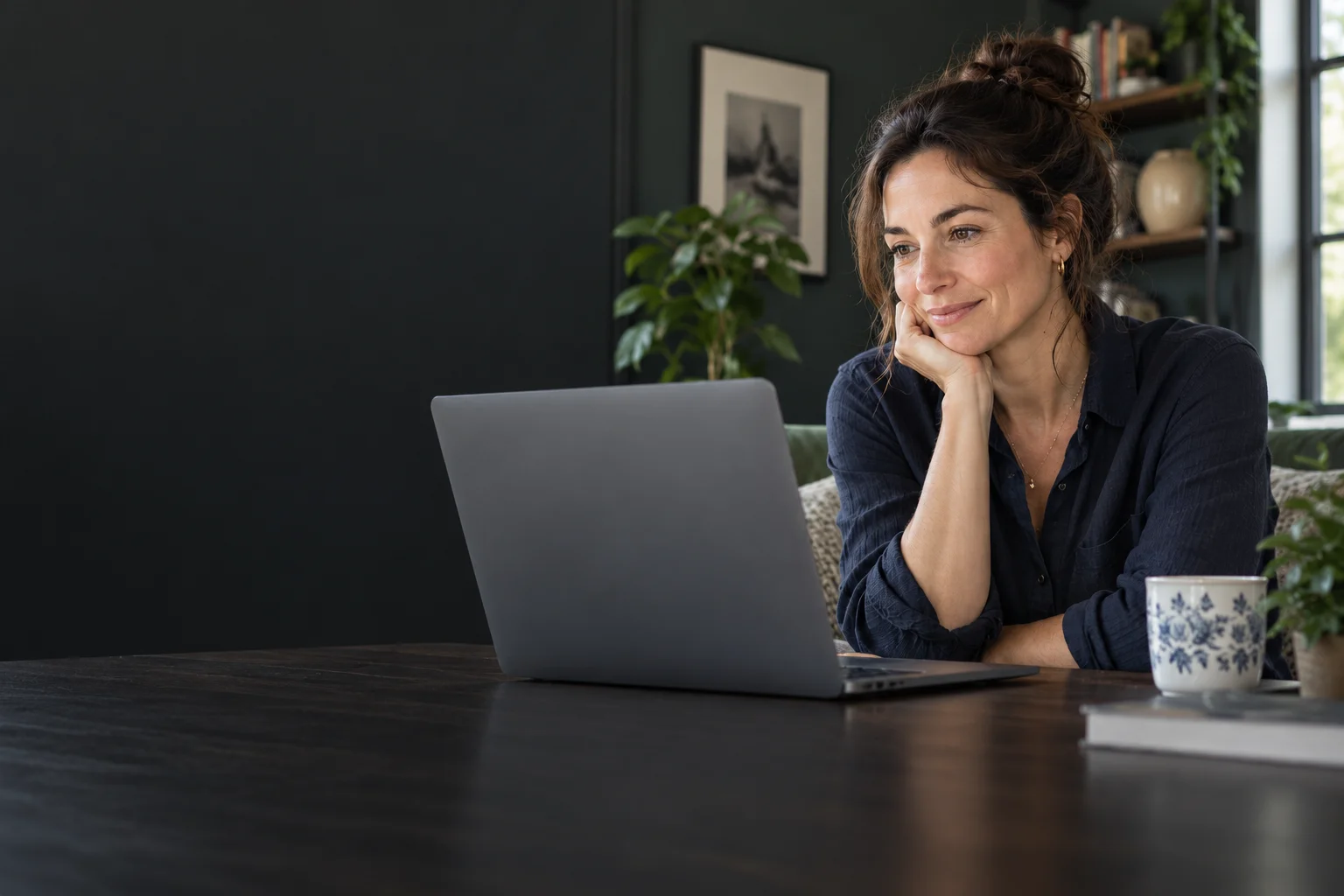 An illustrative portrait of a woman enjoying a conversation at her laptop.